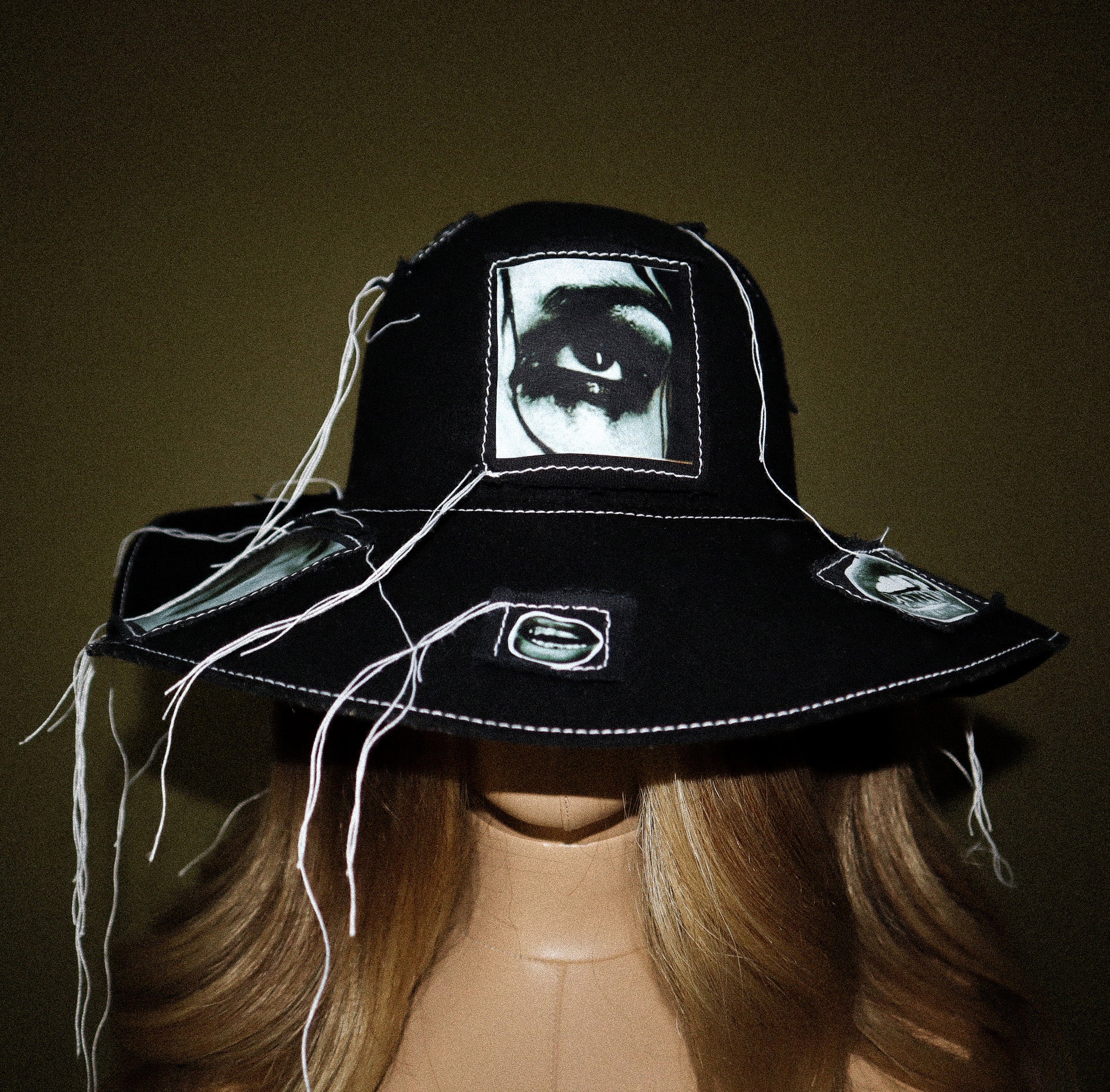 100% WOOL HAT W/ BLACK + WHITE EYE GRAPHICS + TOPSTITCH DETAIL