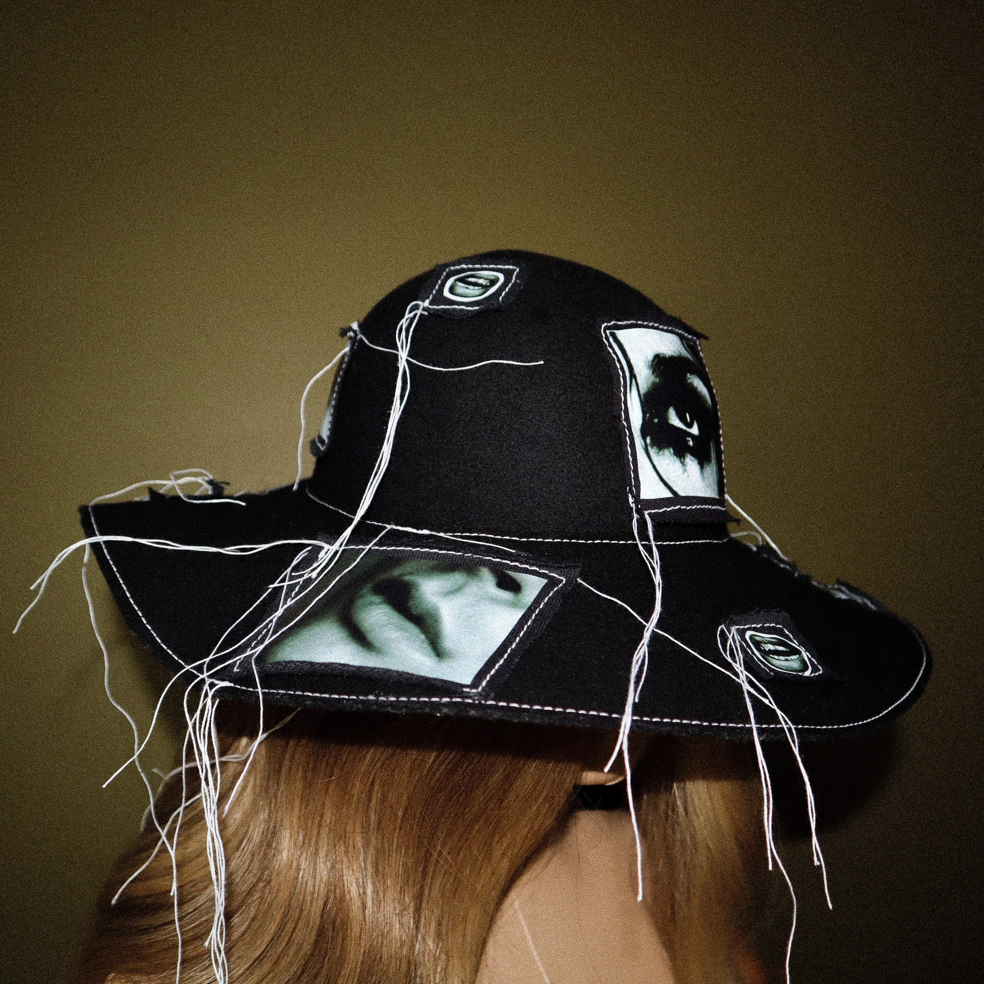 100% WOOL HAT W/ BLACK + WHITE EYE GRAPHICS + TOPSTITCH DETAIL