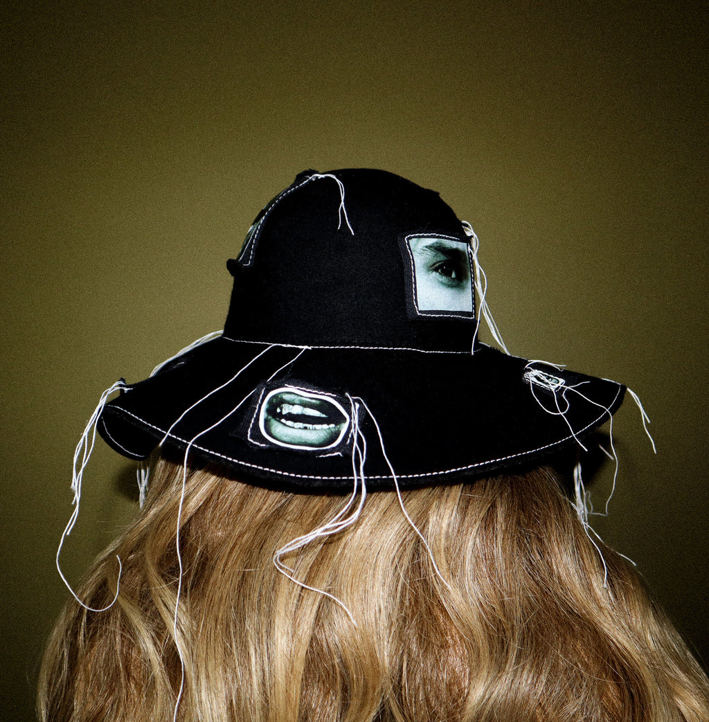 100% WOOL HAT W/ BLACK + WHITE EYE GRAPHICS + TOPSTITCH DETAIL