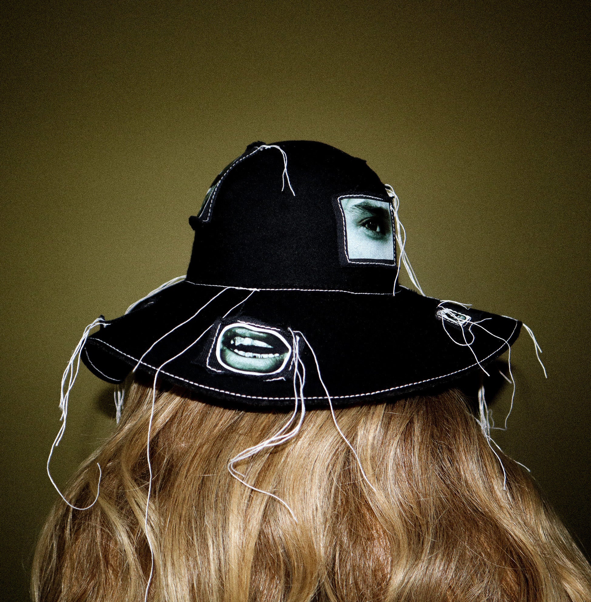100% WOOL HAT W/ BLACK + WHITE EYE GRAPHICS + TOPSTITCH DETAIL