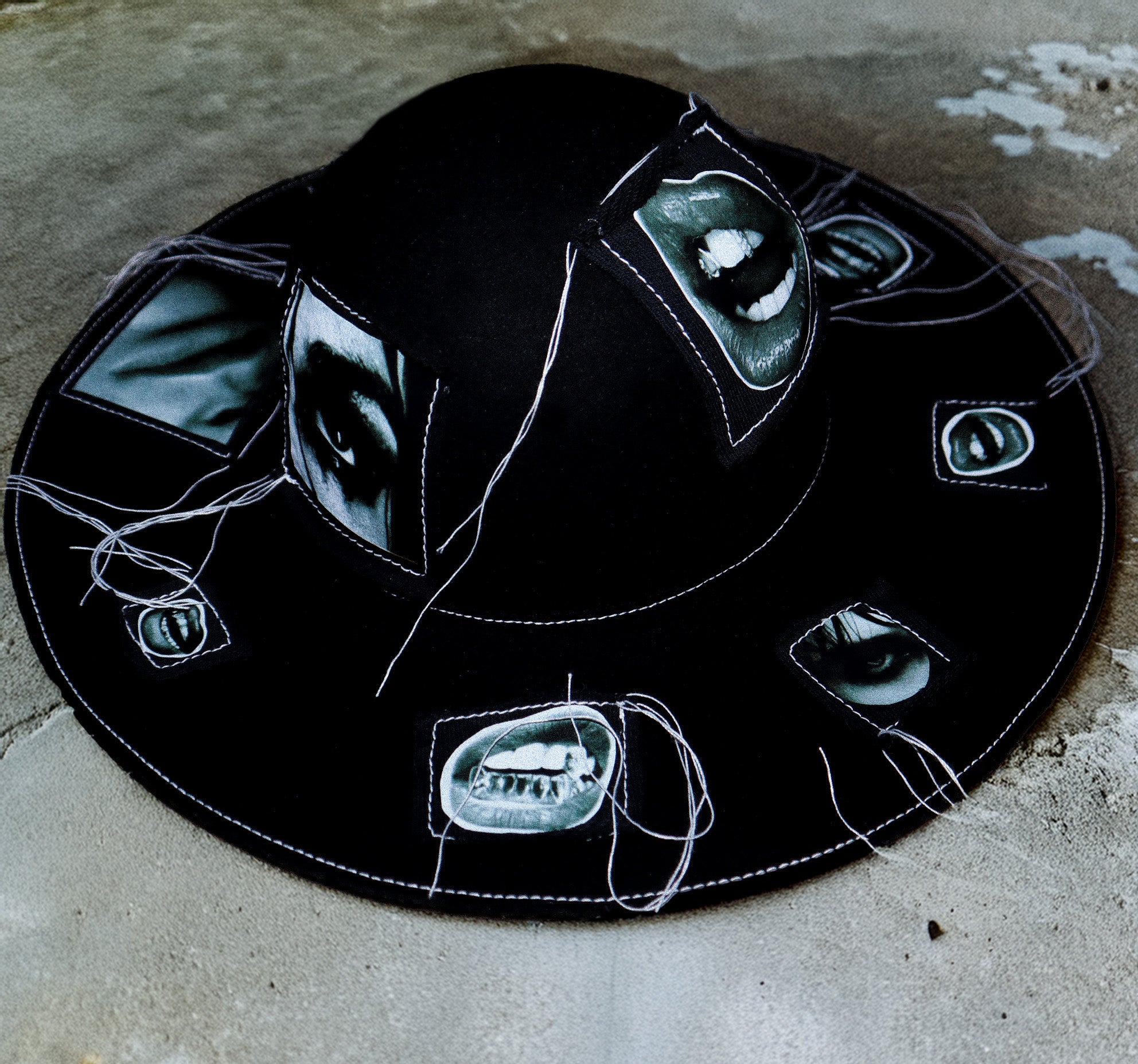100% WOOL HAT W/ BLACK + WHITE EYE GRAPHICS + TOPSTITCH DETAIL