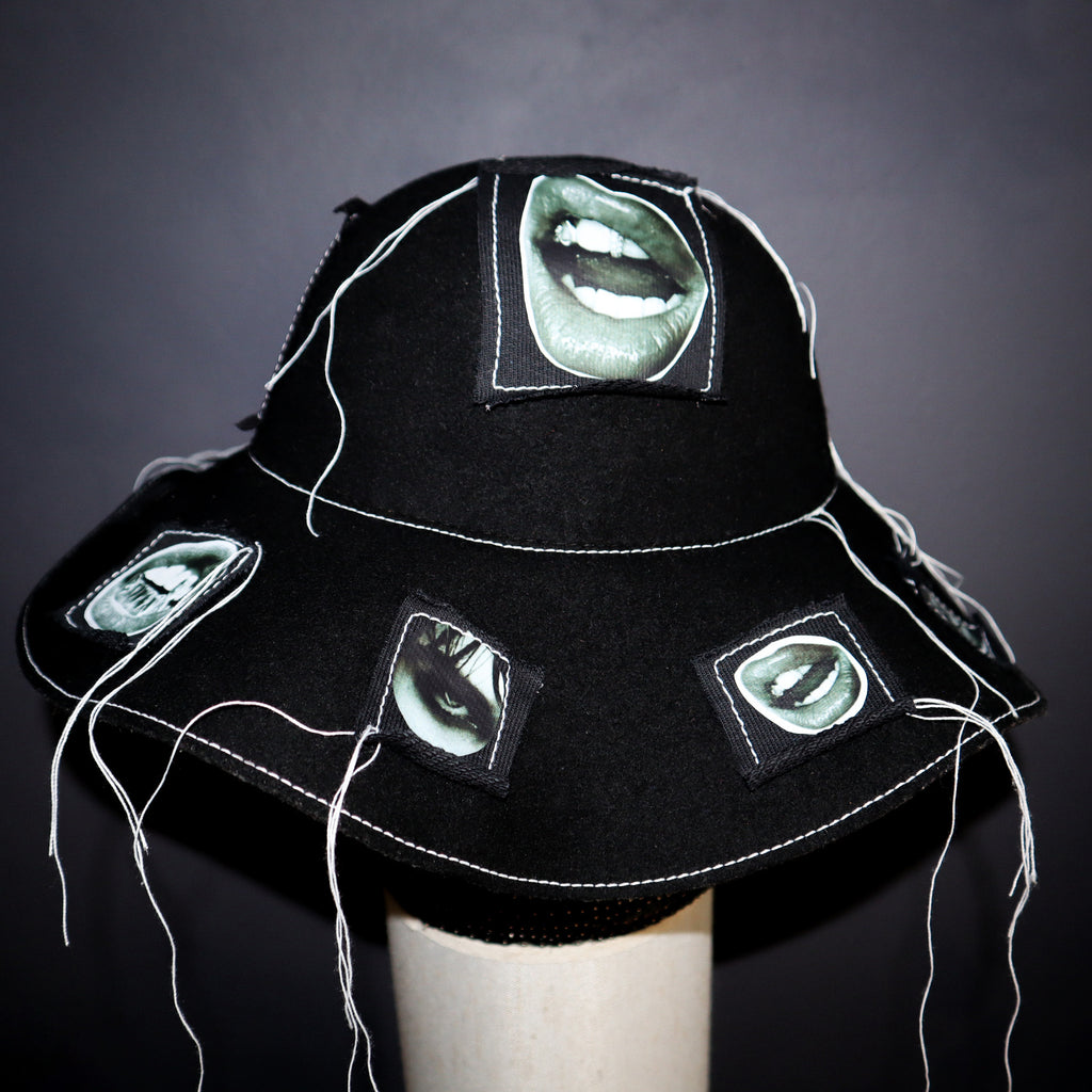 100% WOOL HAT W/ BLACK + WHITE EYE GRAPHICS + TOPSTITCH DETAIL