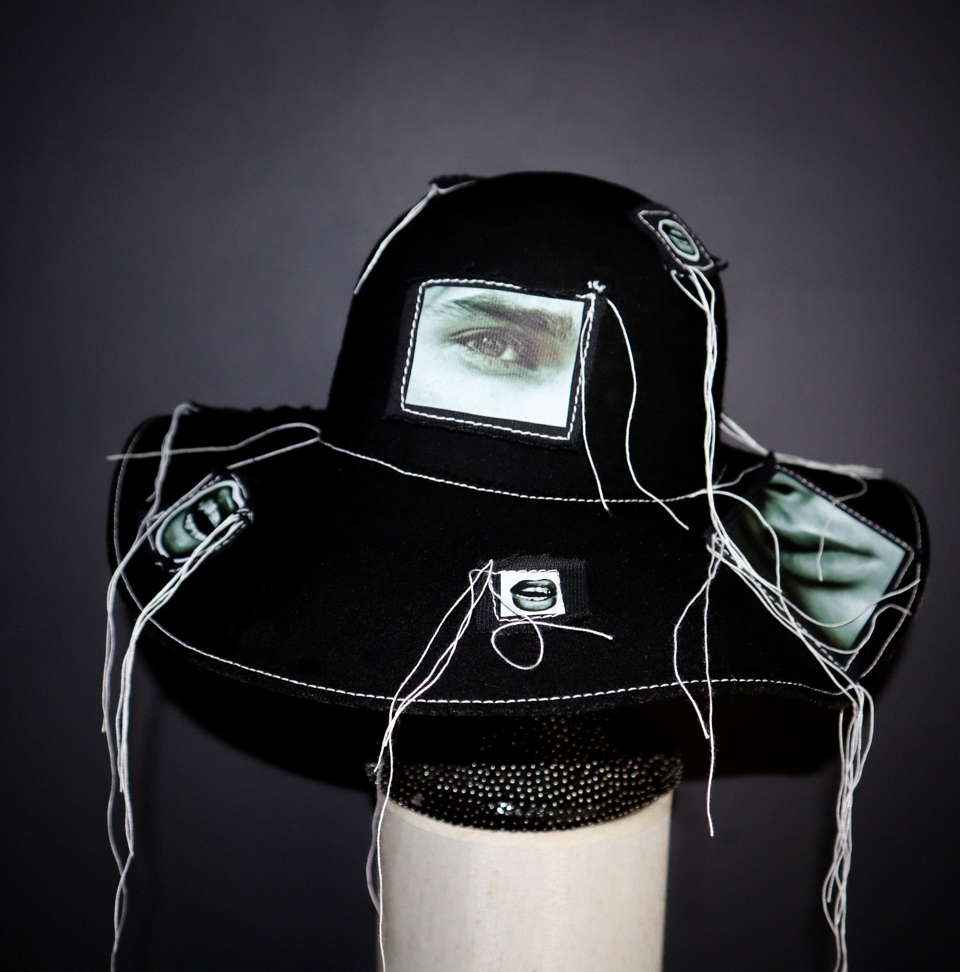 100% WOOL HAT W/ BLACK + WHITE EYE GRAPHICS + TOPSTITCH DETAIL