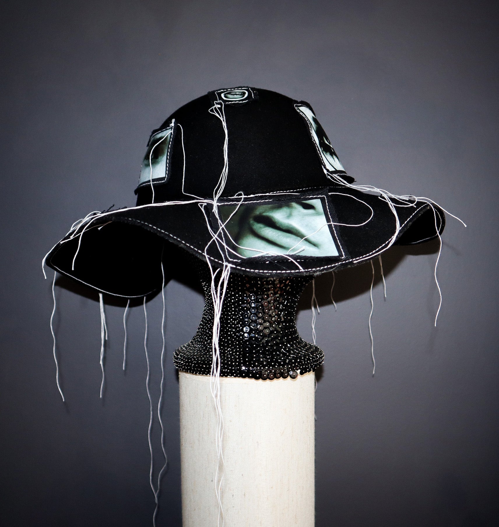 100% WOOL HAT W/ BLACK + WHITE EYE GRAPHICS + TOPSTITCH DETAIL