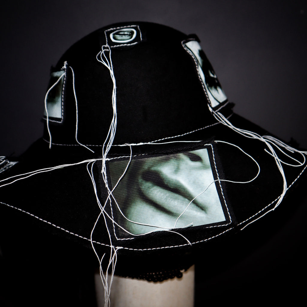 100% WOOL HAT W/ BLACK + WHITE EYE GRAPHICS + TOPSTITCH DETAIL