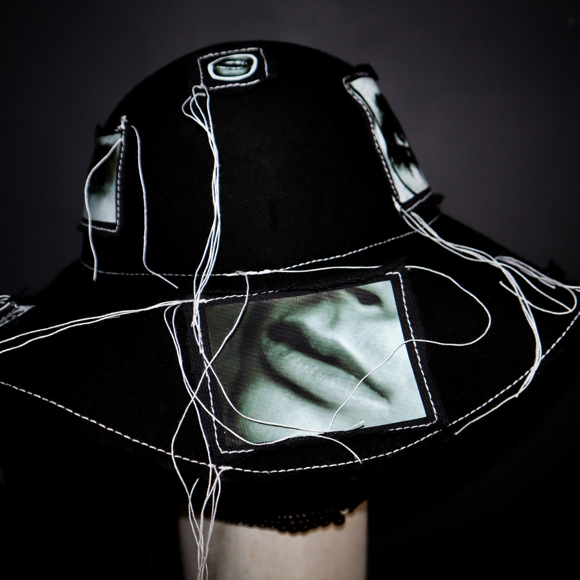 100% WOOL HAT W/ BLACK + WHITE EYE GRAPHICS + TOPSTITCH DETAIL